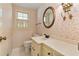 Cozy bathroom featuring vintage wallpaper, a marble countertop, and an oval mirror at 4261 Brookview Se Dr, Atlanta, GA 30339