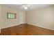 Bedroom with hardwood floors and a mirror above the baseboard, illuminated by a ceiling fan at 4261 Brookview Se Dr, Atlanta, GA 30339
