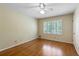 Bright bedroom with hardwood floors, a ceiling fan, and shuttered windows at 4261 Brookview Se Dr, Atlanta, GA 30339