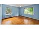 Light blue bedroom features hardwood floors and natural light from two windows at 4261 Brookview Se Dr, Atlanta, GA 30339