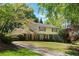 Charming two-story home featuring a well-manicured lawn and a long driveway at 4261 Brookview Se Dr, Atlanta, GA 30339
