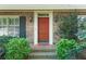 Inviting front entrance showcasing a brick facade, lantern sconces, and manicured shrubbery at 4261 Brookview Se Dr, Atlanta, GA 30339