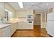 Clean kitchen with white cabinets, double wall-mount ovens and updated appliances and hardwood flooring at 4261 Brookview Se Dr, Atlanta, GA 30339
