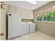 Bright laundry room with washer, dryer and window, featuring lots of natural light at 4261 Brookview Se Dr, Atlanta, GA 30339