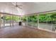 Expansive screened porch with brick flooring and a ceiling fan, perfect for outdoor living at 4261 Brookview Se Dr, Atlanta, GA 30339