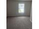 Bedroom with neutral carpet, light-colored walls, and a window at 6423 Rosetta Drive, Unit 66 # 66, South Fulton, GA 30331