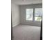 Carpeted bedroom featuring bright natural light through large windows at 6423 Rosetta Drive, Unit 66 # 66, South Fulton, GA 30331