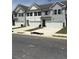 View of multiple two-story homes featuring attached garages and well-kept lawns at 6423 Rosetta Drive, Unit 66 # 66, South Fulton, GA 30331
