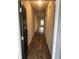 Hallway with wood floors and a window at the end for natural light at 6423 Rosetta Drive, Unit 66 # 66, South Fulton, GA 30331
