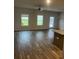 Living room with modern wood floors and plenty of natural light from backyard windows at 6423 Rosetta Drive, Unit 66 # 66, South Fulton, GA 30331