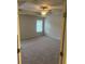 Main bedroom with plush carpet, ceiling fan, and a window overlooking outside at 6423 Rosetta Drive, Unit 66 # 66, South Fulton, GA 30331