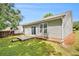 Landscaped backyard with concrete patio and sliding glass door access to the house at 712 Brambling Way, Stockbridge, GA 30281