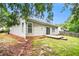 A home's backyard featuring a concrete patio and sliding glass door entry at 712 Brambling Way, Stockbridge, GA 30281