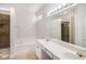 Large bathroom with a built-in bathtub and a long sink countertop with a large mirror at 712 Brambling Way, Stockbridge, GA 30281