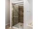 Modern bathroom featuring a glass-door shower with decorative marble-style tile surround at 712 Brambling Way, Stockbridge, GA 30281