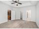 Large bedroom with views into the kitchen and bathroom plus tray ceiling and ceiling fan at 712 Brambling Way, Stockbridge, GA 30281