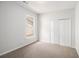 Cozy bedroom space features carpet flooring, a window with natural light, and closet space at 712 Brambling Way, Stockbridge, GA 30281