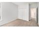 Bright bedroom with a closet and view to another room, showing neutral colored carpet at 712 Brambling Way, Stockbridge, GA 30281