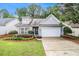 Charming single-story home with a well-maintained lawn, lovely landscaping, and attached two-car garage at 712 Brambling Way, Stockbridge, GA 30281