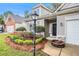 Inviting home exterior with tidy flower beds, established shrubs, and a well-manicured lawn at 712 Brambling Way, Stockbridge, GA 30281