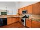 Beautiful kitchen featuring wood cabinets, stainless steel appliances, and hardwood flooring at 712 Brambling Way, Stockbridge, GA 30281