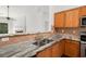 Granite counters and stainless appliances accent this kitchen open to the living area with hardwood floors at 712 Brambling Way, Stockbridge, GA 30281