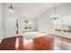 Bright living room featuring wood floors, fresh neutral paint, statement chandeliers, and a large window at 712 Brambling Way, Stockbridge, GA 30281