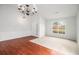 Spacious living area with hardwood floors, fresh neutral paint, statement chandelier and bright natural light at 712 Brambling Way, Stockbridge, GA 30281