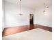 Bright living space featuring hardwood floors, fresh neutral paint, statement chandelier, and modern trim at 712 Brambling Way, Stockbridge, GA 30281