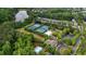 Aerial view showcasing community amenities including tennis courts, pool, and surrounding lush greenery at 813 Poplar Ter, Canton, GA 30115