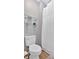 Modern bathroom with sleek fixtures, a toilet, shower with curtain, and decorative shelves at 813 Poplar Ter, Canton, GA 30115