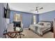 Cozy bedroom boasts a ceiling fan, carpet flooring, and natural light from the window at 813 Poplar Ter, Canton, GA 30115