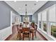 Spacious dining room offering hardwood floors, a modern chandelier, and expansive windows at 813 Poplar Ter, Canton, GA 30115