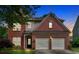 Charming two-story brick home with an attached two-car garage and well-manicured landscaping at 813 Poplar Ter, Canton, GA 30115