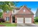 Charming two-story brick home featuring an attached two-car garage and a well-manicured front lawn at 813 Poplar Ter, Canton, GA 30115