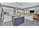 Stylish kitchen featuring a central island, white cabinetry, modern lighting, and open layout at 813 Poplar Ter, Canton, GA 30115