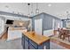 Beautiful open kitchen featuring an island with a butcher block countertop and stylish pendant lighting at 813 Poplar Ter, Canton, GA 30115
