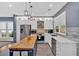 Bright kitchen featuring white cabinets, granite countertops, stainless steel appliances, and a center island at 813 Poplar Ter, Canton, GA 30115