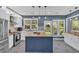 Modern kitchen with white cabinets, a blue island, stainless steel appliances, and tile backsplash at 813 Poplar Ter, Canton, GA 30115
