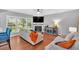 Cozy living room with a fireplace, hardwood floors, large windows, and comfortable seating at 813 Poplar Ter, Canton, GA 30115