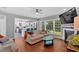 Bright living room overlooking the kitchen with hardwood floors, large windows, and a fireplace at 813 Poplar Ter, Canton, GA 30115