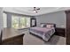 Spacious main bedroom featuring tray ceilings, large windows, and neutral carpeting at 813 Poplar Ter, Canton, GA 30115