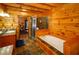 A full wooden bathroom with a shower, a soaking tub, and double vanities at 1225 Pitts Chapel, Newborn, GA 30056