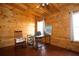 Inviting bedroom features warm wood walls, hardwood floors, and serene window views at 1225 Pitts Chapel, Newborn, GA 30056