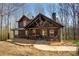 Charming log cabin featuring a welcoming front porch, exposed beams, and well-kept landscaping at 1225 Pitts Chapel, Newborn, GA 30056