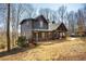 Charming log cabin home featuring a covered porch and well-maintained landscaping at 1225 Pitts Chapel, Newborn, GA 30056