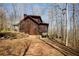 Side view of log home showing its wood siding and setting in a wooded area at 1225 Pitts Chapel, Newborn, GA 30056