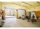 Open garage interior with roll up door, concrete floor, and electrical panel at 1225 Pitts Chapel, Newborn, GA 30056