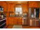 Spacious kitchen with wooden cabinets, stainless steel appliances, and hardwood floors at 1225 Pitts Chapel, Newborn, GA 30056