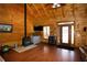 Open living room features hardwood floors, a wood-burning stove, and natural light at 1225 Pitts Chapel, Newborn, GA 30056